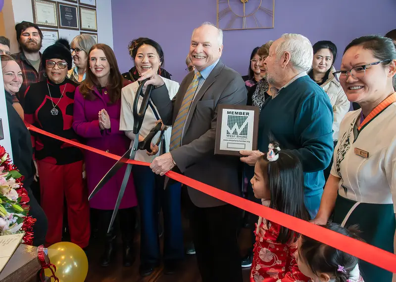 Ribbon-cutting for Care Healing Hands, a spa in Westlake, Ohio, with the owners and the West Shore Chamber